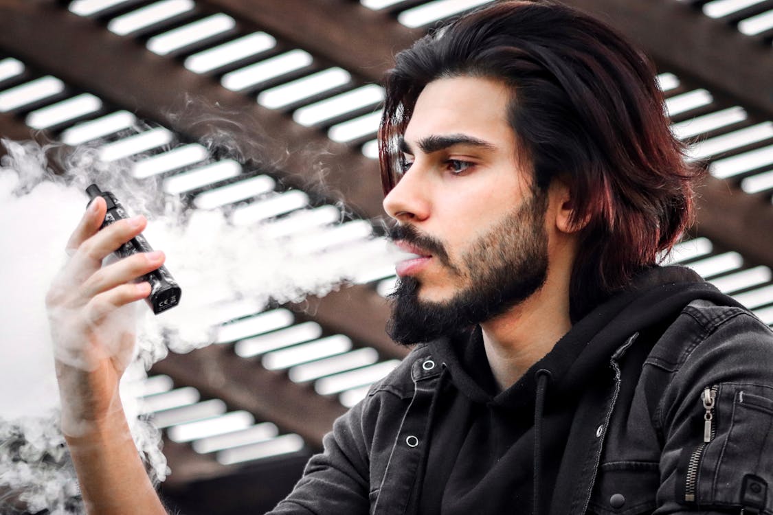 A handsome man is using a FUUMY disposable vapes | FUUMY