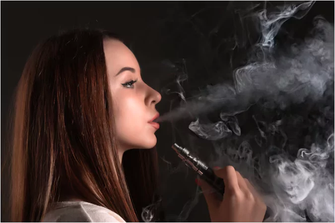 a young girl smoking vape